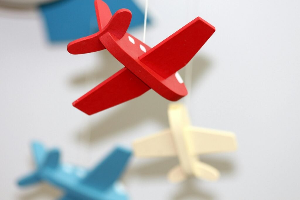 pexels-photo-255514-255514 A close-up of colorful wooden airplane toys in a mobile, perfect for nursery décor.
